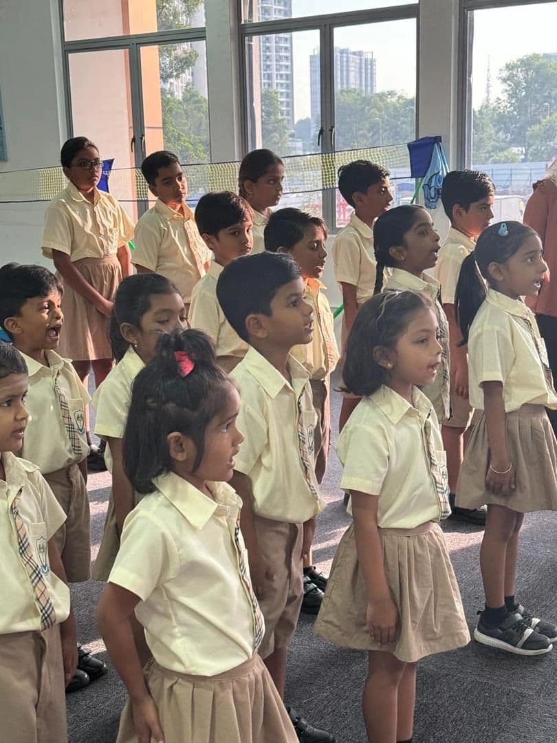 Primary students in cream uniforms standing in a line