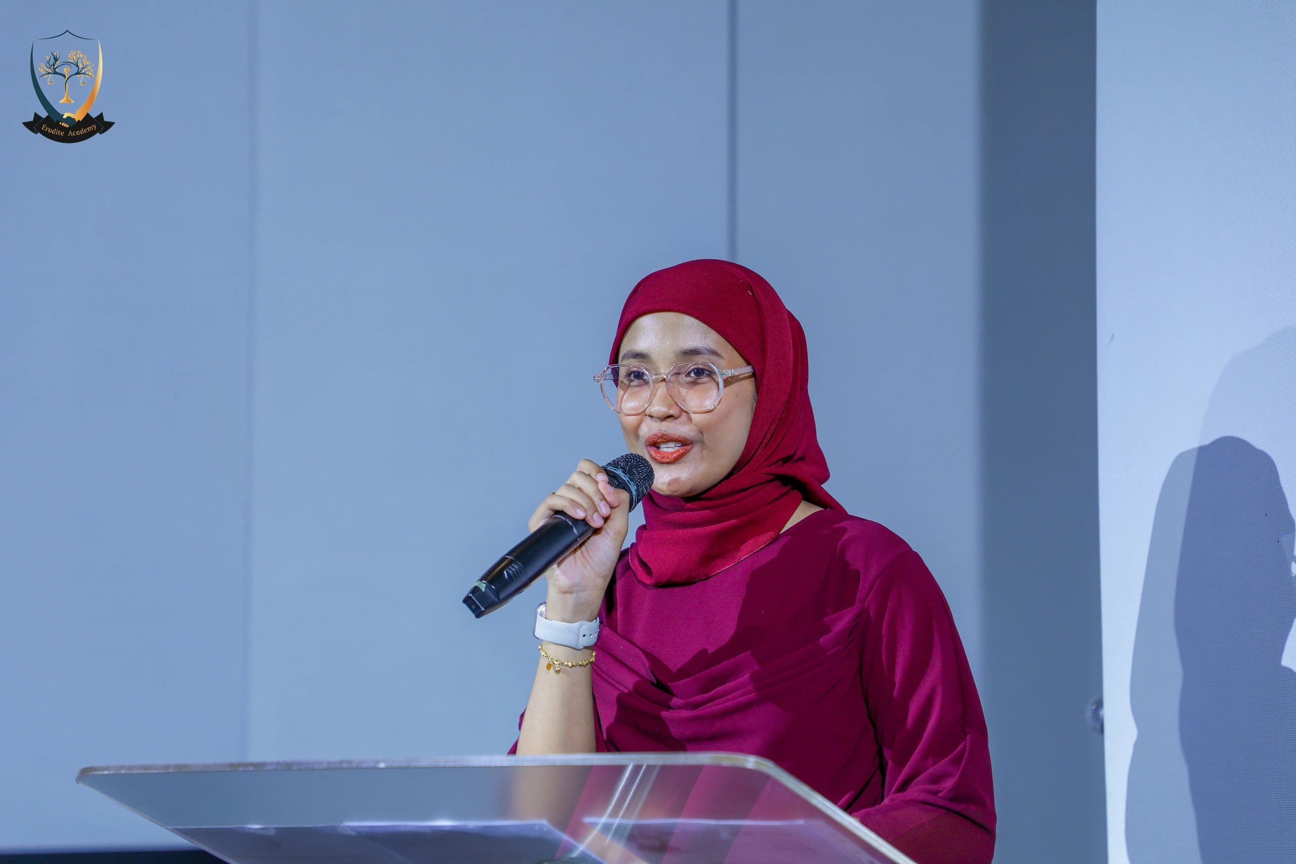 A member of staff speaking at a podium